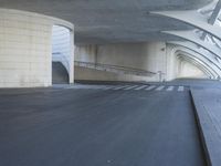 this is an outdoor space with concrete walls and stairs leading to a parking garage area