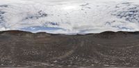 three horses and people walking near an arid area in the middle of nowhere land under a cloudy sky