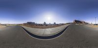 a 360 - eye image taken with fish eye lens, showing the street and road area in the background