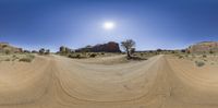 a desert scene in a panorama lens of the camera, and looking at the sun