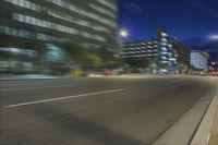 an image of an urban setting in motion on the street at night time during the day