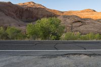 a lone street sign on the side of the road in front of mountains in arizona