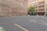 two people walking down a city street next to tall buildings and parking spaces covered with signs