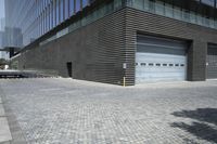 a building with an outside parking lot and garage area in the background with the door open