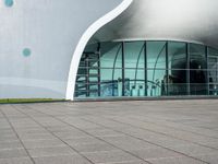 an open window on a large building that is very futuristic looking in the day time