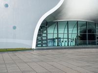 an open window on a large building that is very futuristic looking in the day time