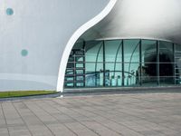 an open window on a large building that is very futuristic looking in the day time