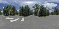 three wide angle shots show a winding road, trees and sky with clouds overhead in the background