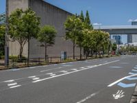 empty road with white lines on the streets of city area against cloudy blue sky on a sunny day