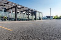 a storefront in an empty parking lot with bicycles outside of it and parked cars behind