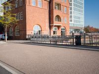 the large building is made of concrete and has metal railings around it, which are made of brick