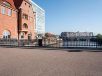 the large building is made of concrete and has metal railings around it, which are made of brick