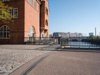 the large building is made of concrete and has metal railings around it, which are made of brick