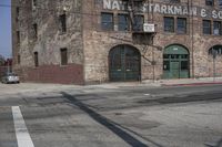 the shadow is on the street sign near the building in front of it and on the sidewalk are buildings