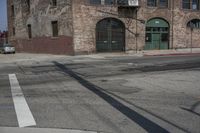 the shadow is on the street sign near the building in front of it and on the sidewalk are buildings