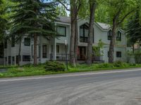 an empty street lined with trees and a mountain range in the distance in the back