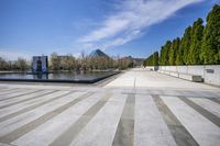 Asphalt Road and Concrete: Reflections on the Water