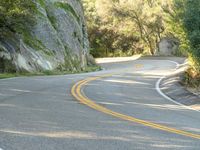 Asphalt Road Curving Rock Wall