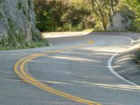 Asphalt Road Curving Rock Wall