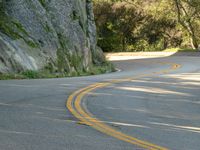 Asphalt Road Curving Rock Wall