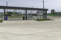 an empty terminal with no passengers on the tarmac, and a man in the distance