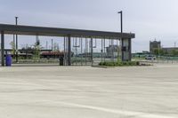 an empty terminal with no passengers on the tarmac, and a man in the distance