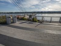 people walk along the river in the evening along the boardwalk in an urban area with concrete floors