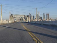 a city skyline with a bridge across it in the middle of the day to give out one