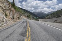 Asphalt Road with Low Mountain Landscape in Colorado