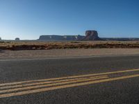 Asphalt Road in Monument Valley, Utah at Dawn