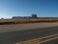 Asphalt Road in Monument Valley, Utah at Dawn