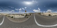 a panorama lens image of a desert road and sky with clouds on the background in a spherical frame