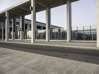 the front entrance of an airport with the sky above it and columns on both sides