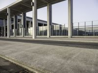 the front entrance of an airport with the sky above it and columns on both sides