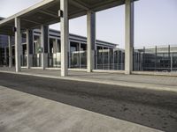 the front entrance of an airport with the sky above it and columns on both sides