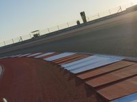 an orange and white racing track with red and white strips on the front corner of the track