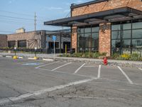 the empty street outside of the business district is empty and deserted with vehicles parked in it