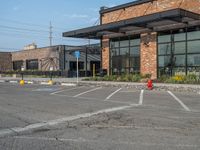 the empty street outside of the business district is empty and deserted with vehicles parked in it