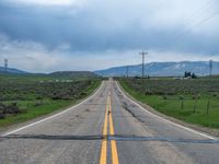 Asphalt Road in Utah: Clouds Above a Rural Landscape