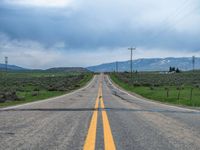 Asphalt Road in Utah: Clouds Above a Rural Landscape