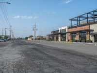 the empty street outside of the business district is empty and deserted with vehicles parked in it