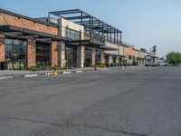 the empty street outside of the business district is empty and deserted with vehicles parked in it