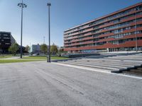 a concrete stage in front of a building on a sunny day outside the stadium or school