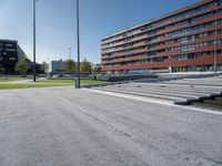 a concrete stage in front of a building on a sunny day outside the stadium or school