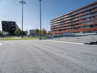 a concrete stage in front of a building on a sunny day outside the stadium or school