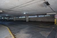 empty parking garage with a parking meter visible between it and the road closed to the public