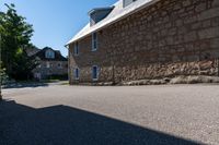 a man on a skateboard is riding on the street by an old stone building