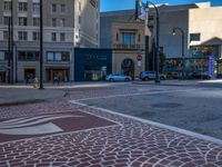 an empty intersection of two streets with street signs on each corner and an arrow in the center