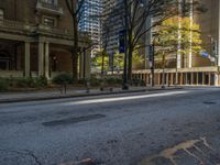 two benches on the side of a street in front of some tall buildings and buildings