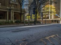 two benches on the side of a street in front of some tall buildings and buildings